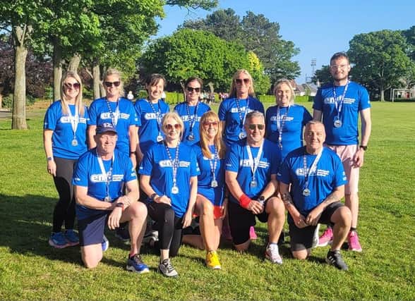 Wearing their race medals and T shirts, Kirkcaldy Wizards who took part in the Edinburgh Half and Full Marathons on Sunday (Submitted pics)