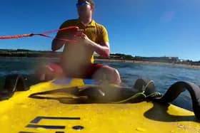 Jake Muir, RNLI lifeguard, went into the water on a rescue board to assist the paddleboarders.