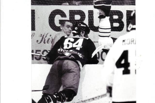Doug Marsden, Paisley Pirates, sends a Fife Flyers player tumbling over the boards at Kirkcaldy  (Pic: Bill Dickman)