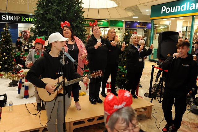 Volunteers from Nourish singalong to Jingle Bells before the big switch on.