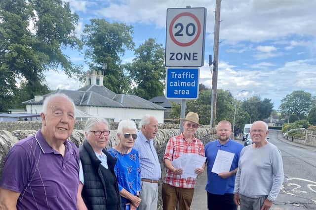 Residents in Cupar's Brighton Road hand a petition to Councillor Stefan Hogan-Radu calling for the speed limit to be reduced from 30mph to 20mph along the full length of the road.  (Pic: submitted)
