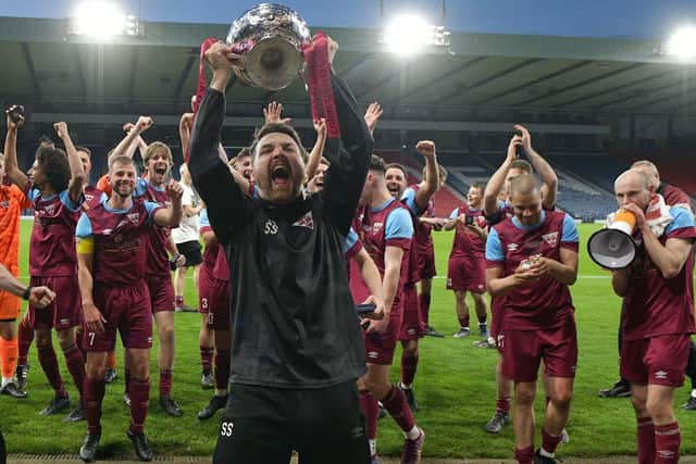 Cupar Hearts manager Sean Simpson holds aloft the Scottish Amateur Cup last year after the 2-1 victory over Steins Thistle at Hampden Park (Pic by Michael Gillen)