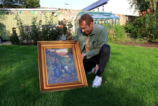 Orchard Croft owner Matt Kirkbride poses with a painting from David Alison in the garden where it was painted (Pic:  Danyel VanReenen)