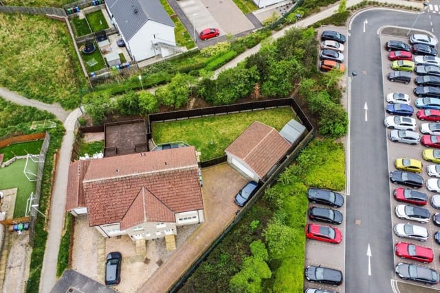 Overhead view showing property and large corner plot.