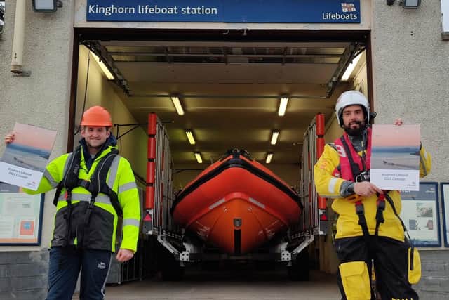 Donnie Maclean and Ralph Johnston with their calendar at Kinghorn lifeboat station. Pic: Kinghorn RNLI