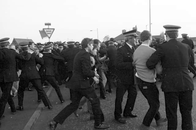 Police arrest members of the NUM miners' union picket line trying to stop lorries delivering coal to Ravenscraig steelworks in May 1984.