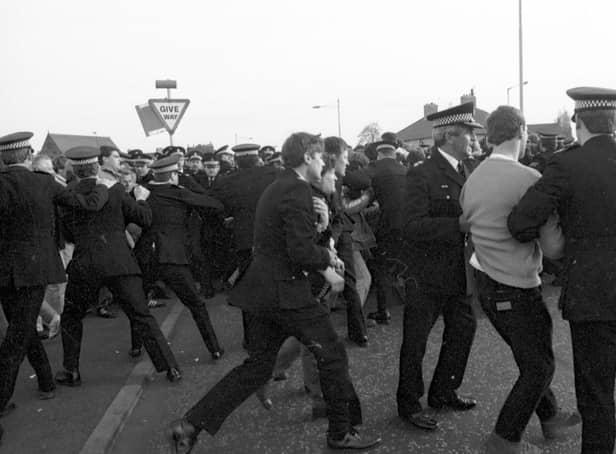 Police arrest members of the NUM miners' union picket line trying to stop lorries delivering coal to Ravenscraig steelworks in May 1984.