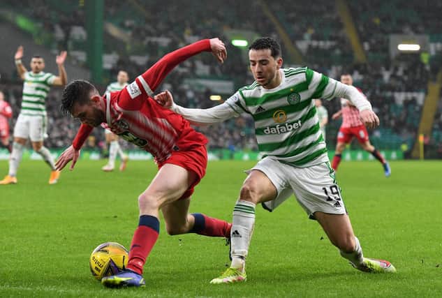 Sam Stanton shields the ball from Celtic's Mikey Johnston at Parkhead on Sunday.  (Pic: Mark Runnacles/Getty Images)