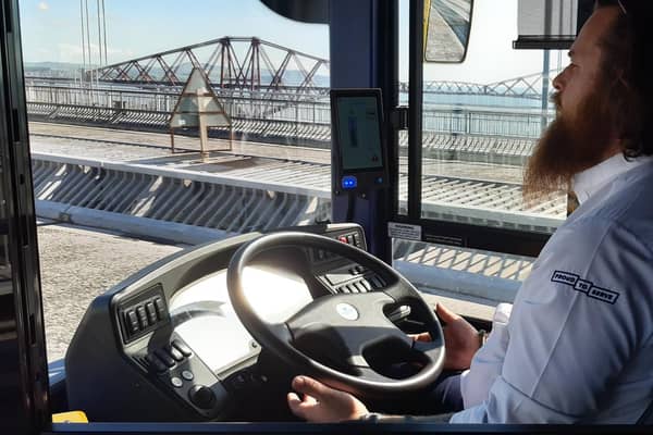The driver demonstrating the bus in autonomous mode by taking his hands off the wheel while crossing the Forth Road Bridge. Picture: The Scotsman