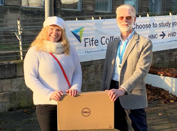 John Wincott, Environmental Services Coordinator at Fife College, presents Climate Change Scholarship winner, Alison Major, with her laptop outside the College's Kirkcaldy Campus.