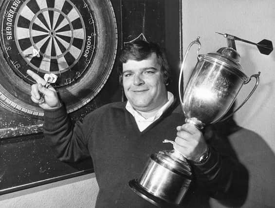 Jocky Wilson in Kirkcaldy with the Embassy Darts World Championship trophy after beating John Lowe in 1982