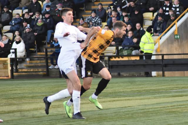 Danny Denholm attempts to break clear from Ryan Williamson