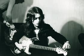 Rory Gallagher tuning up in the studo (Pic: Mick Rock/Strange Music)
