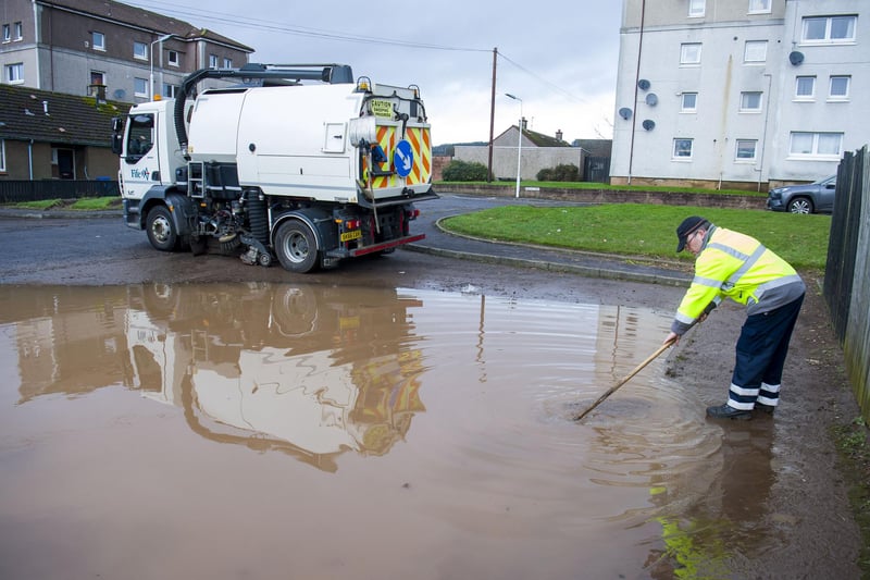 Assessing the depth of the water on this road in a residential area of Cupar.