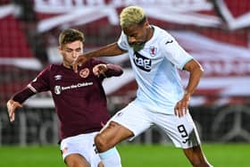 Hearts Jamie Brandon challenges Manny Duku during the Betfred Cup match at Tynecastle in October