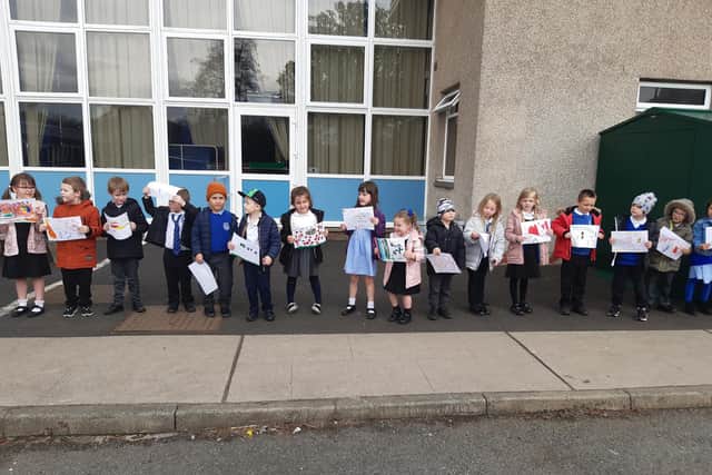 Pupils at St Marie's RC Primary lined up with their artwork to say farewell to janitor George who retired after 10 and a half years in the job.