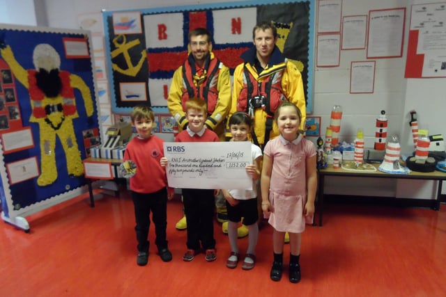Anstruther Lifeboat Volunteers Barry Gourlay and Euan Hoggan collect a cheque for £1152 raised by pupils at Anstruther Primary School in 2015.