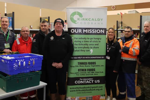 Ian Campbell (left), chair of Kirkcaldy Foodbank, meets some of the Briggs Marine team.