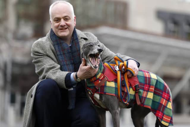 : Scottish Green MSP Mark Ruskell poses with former racing greyhound, seven year old Bluesy, outside the Scottish Parliament. (Photo by Jeff J Mitchell/Getty Images)