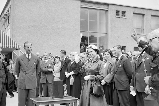 The Queen waves to miners at Rothes Colliery watched by the Duke