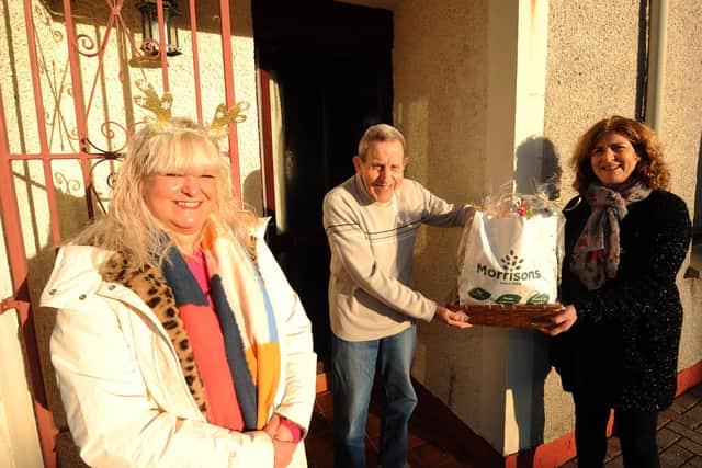 Mandy Henderson (right) with a volunteer delivering Christmas hampers last year.