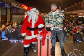 Musician Cammy Barnes joined Santa (Rotarian Rai Valente) on stage for the light switch on in Leven on Saturday.  (Pic: Andrew Beveridge)