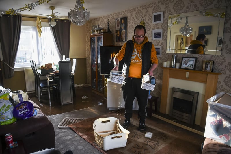 Kinloss Park resident Andrew McIntosh looks through his damaged belongings and tried to salvage what he can.