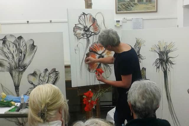 A class taking in an art demonstration at Kirkcaldy Art Club.