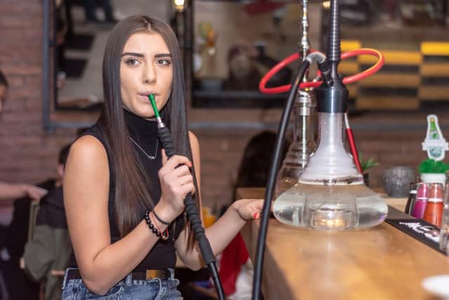 Shisha bars or dens, also known as hookah lounges, typically see patrons share flavoured tobacco from a communal hookah pipe or from one placed at each table or a bar.