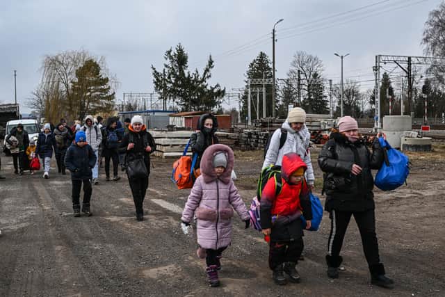 Women and children who have fled war-town Ukraine walk to board a train to transport them to Przemysl main train station after crossing the Polish Ukrainian border  (Photo by Omar Marques/Getty Images)
