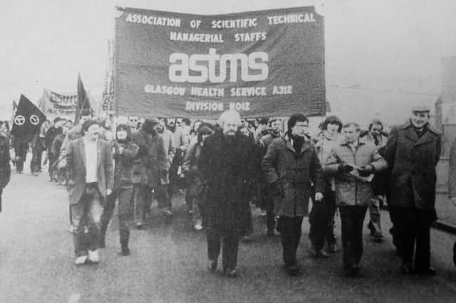 12 workers from Victoria Hospital labs staged a sit-in as part of a long-running industrial dispute with Fife Health Board. That led to them police staging a dawn raid and charging them under 108-year old law. They were subsequently acquitted in court. Picture shows a mass protest in support of workers, led by Henry McLeish, then a councillor, and future First Minister; and Central Fife MP Willie Hamilton.