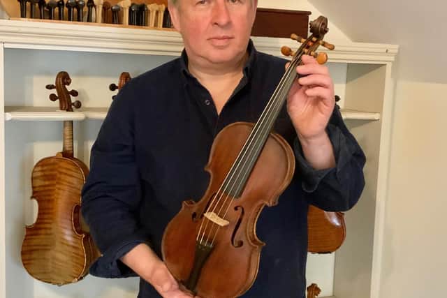 David Rattray is a dedicated maker and restorer of violins, violas and cellos. He is pictured with the fiddle he believes belonged to Scottish amateur musician George Thomson and displays the working hallmarks of the well-regarded Edinburgh violin maker William Ferguson.