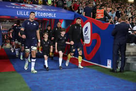 Rhys Edwards, nine, led the Scottish National Team out ahead of the game against Romania (Photo by Julian Finney - World Rugby/World Rugby via Getty Images)