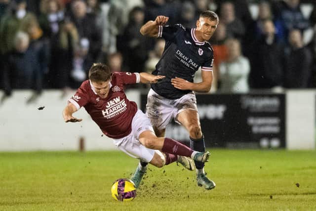 LINLITHGOW, SCOTAND - JANUARY 24: Linlithgow's Sandy Cunningham is fouled by Raith's Tom Lang during a Scottish Cup fourth round match between Linlithgow Rose and Raith Rovers at Prestonfield, on January 24, 2023, in Linlithgow, Scotland. (Photo by Mark Scates / SNS Group)