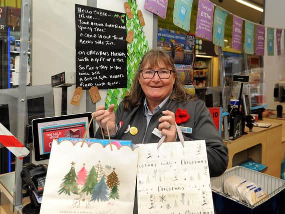 Carole-Anne Paterson with gifts at the 'giving tree' in the Co-op to help give local children a gift this Christmas.  Pic: Fife Photo Agency.