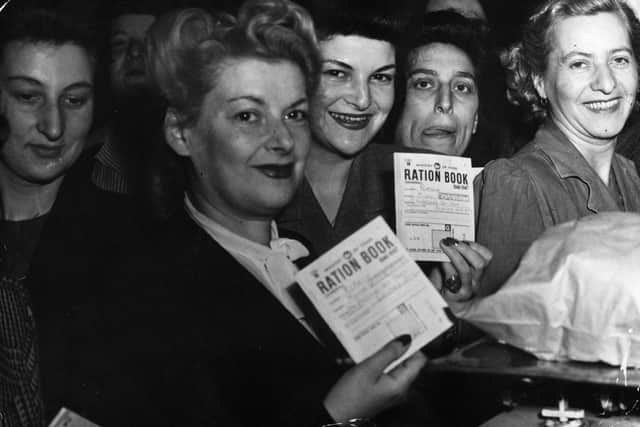 Hungry housewives bring their ration books to London's Petticoat Lane Market during World War II on the first day of bread rationing.  (Pic: Eric Harlow/Keystone/Getty Images)