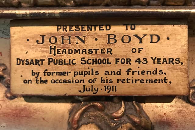 Plaque on the painting of John Boyd that was presented to him upon his retirement.