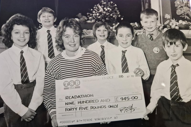 A 1988 readathon at Carleton Primary School in Glenrothes which raised £1000 for the Malcolm Sargeant Cancer Fund. Gillian Pagan, chairman of the Fife committee, accepted the donation  from, (from left) Carolyn Vincent (11), Steven Dunsmuir (10), Carole Ann McIvor (10), Tricia Flinn (10), and nine year olds Kevin Cushnie and Dean Hendry. Picture taken by David Cruickshanks, staff photographer, Glenrothes Gazette