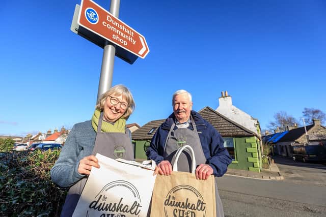 Alison Crook and Brian Lawrie celebrate the arrival of the tourism signposts. (Pic: Mark Alexander.)