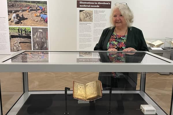 Anne Simpson, chair of the Book of Deer Project, with the manuscript. She said it felt 'unreal' that it was now on show in Aberdeen. PIC: Aberdeen City Council.
