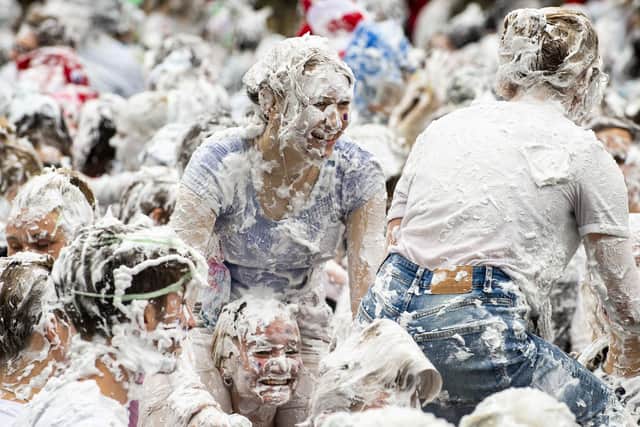 Hundreds of students take part in the traditional Raisin Monday foam fight on St Salvator's Lower College Lawn at the University of St Andrews in Fife (Photo: Lisa Ferguson).
