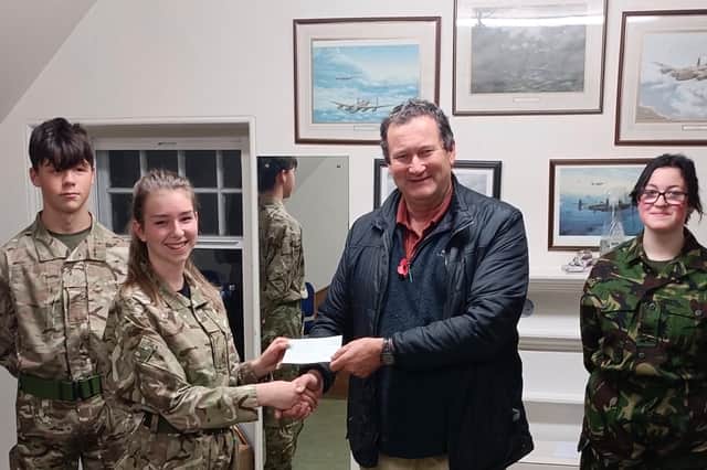 Air Cadet Katie McKie presents a cheque to Henry Paul, Chair of the St Andrews Men's Shed