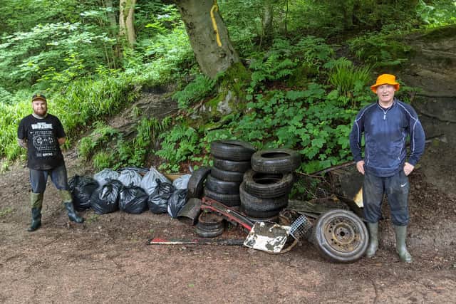 Andrew Dunlop is pictured in the left with Keith Wotherspoon on the right with the bags of rubbish and tyres collected from the Den.