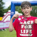 Leo Barker, 11, who had a liver transplant during the pandemic after being diagnosed with cancer sounds the horn at the start of Pretty Muddy Kids (Pic: Lesley Martin)