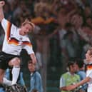 Andreas Brehme leaps high to celebrate in front of West Germany team-mate Jurgen Klinsmann after scoring the winner in 1990 World Cup final (Pic Georges Gobet via Getty Images)