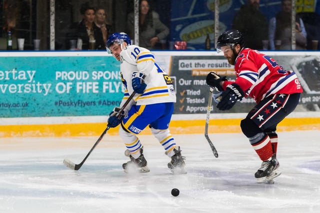 The chase is on for the puck in the game between Kirkcaldy Kestrels and Dundee Comets