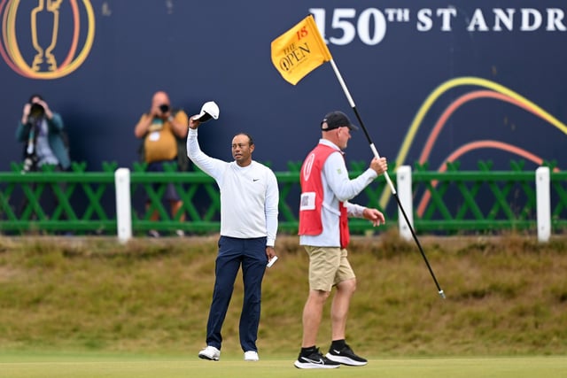 Tiger Woods of the United States acknowledges the crowd as he crosses the Swilcan Bridge during Day Two of The 150th Open at St Andrews Old Course on July 15, 2022 in St Andrews, Scotland. (Photo by Ross Kinnaird/Getty Images)