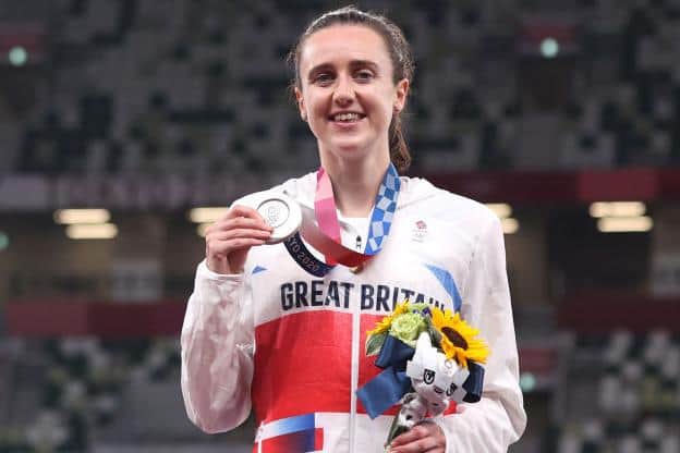Laura Muir holding up her silver medal on the podium after the women's 1,500m race at the Tokyo 2020 Olympic Games today (Photo by Christian Petersen/Getty Images)