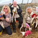 Lottery winners Jannette Wedgeworth, Ken Wedgeworth and Libby Elliot pose with the first new-born lambs of 2023 after providing them with new coats(Pic: Anthony Devlin)