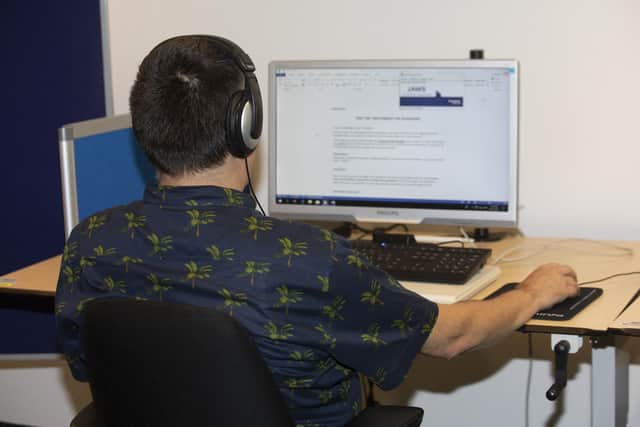 A visually impaired man using reading software on a computer during an assessment as part of a recruitment procedure  (Photo by HATIM KAGHAT/BELGA MAG/AFP via Getty Images)